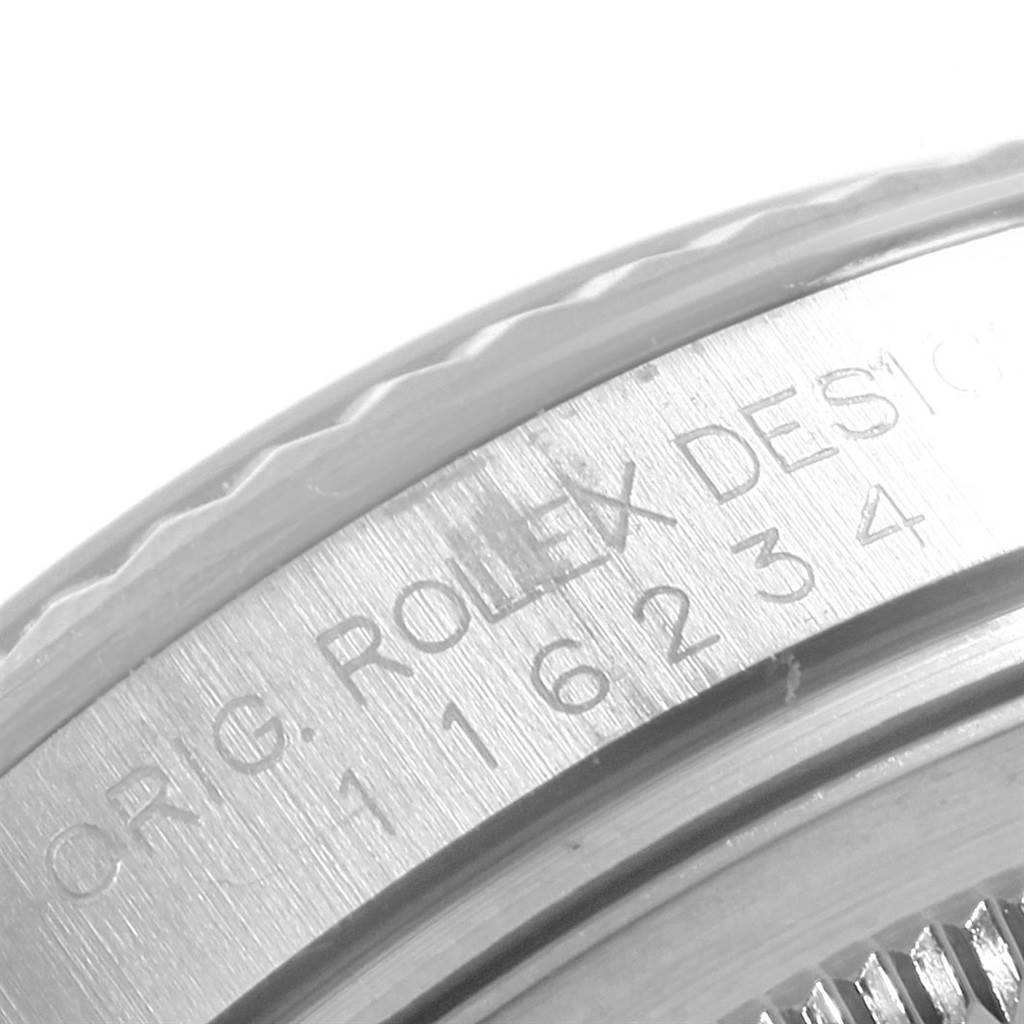 This image shows a close-up of the bezel and engraved serial number on a Rolex Datejust 116234 Men's Stainless Steel Blue Dial 116234 Men's Stainless Steel Blue Dial watch.