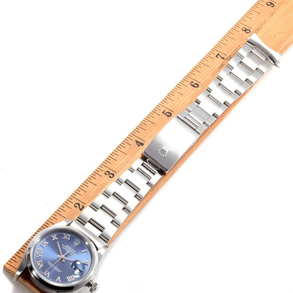 The image shows a Rolex Datejust 16200 Men's Stainless Steel Blue Dial 16200 Men's Stainless Steel Blue Dial watch lying flat with its face and bracelet alongside a ruler for scale.