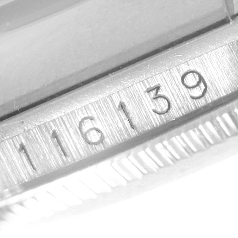 This close-up image shows the serial number engraving on the case of a Rolex Datejust 116139 Men's White Gold Blue Dial 116139 Men's White Gold Blue Dial watch.