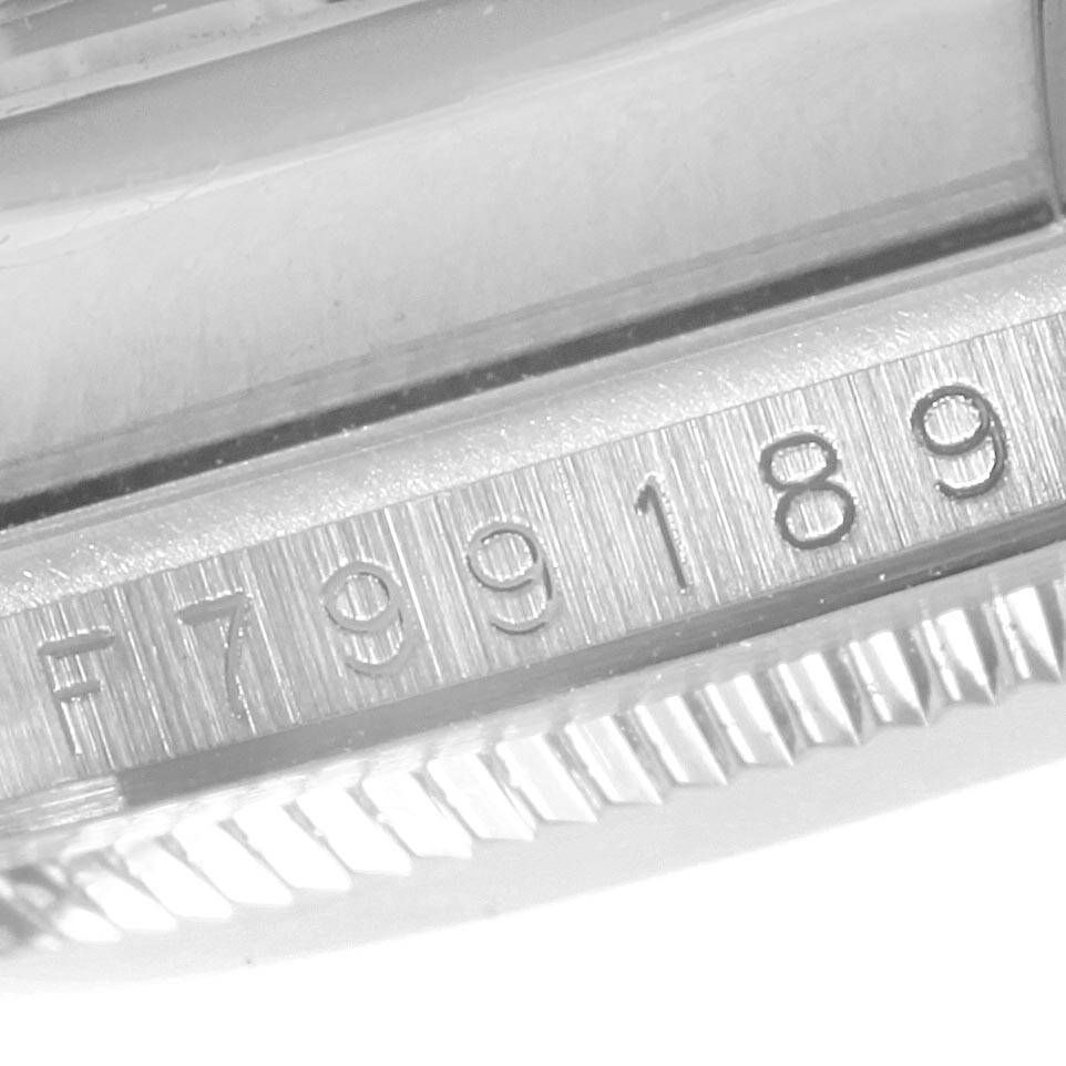 This is a close-up angle of the serial number and fluted bezel on a Rolex Datejust 116139 Men's White Gold Blue Dial 116139 Men's White Gold Blue Dial watch.
