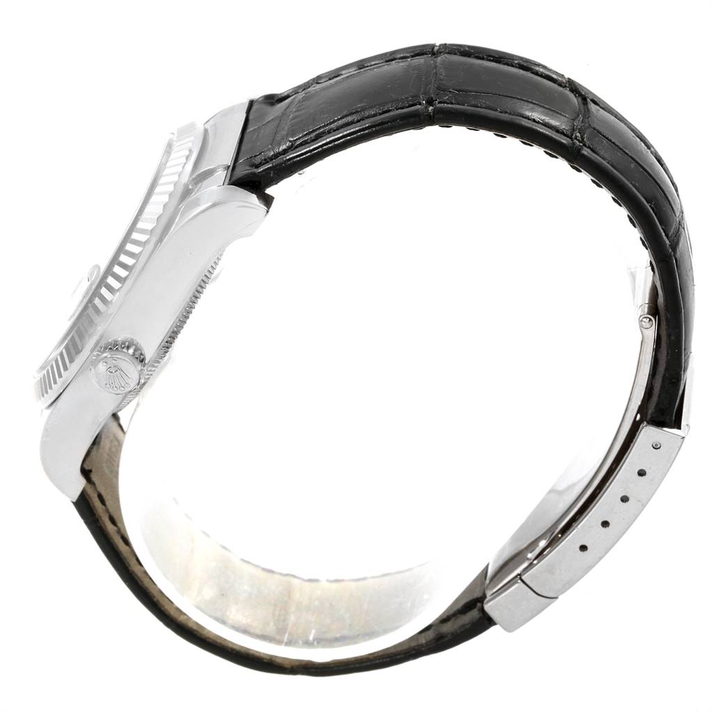 The Rolex Datejust 116139 Men's White Gold Blue Dial 116139 Men's White Gold Blue Dial watch is shown from a side angle, highlighting its crown, bezel, and leather strap.