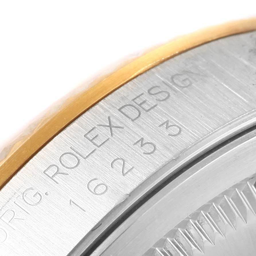 This image shows a close-up of the casing and bezel of the Rolex Datejust 16233 Men
s Stainless Steel Beige Dial 16233 Men
s Stainless Steel Beige Dial watch, highlighting the "ROLEX DESIGN" engraving and model number.