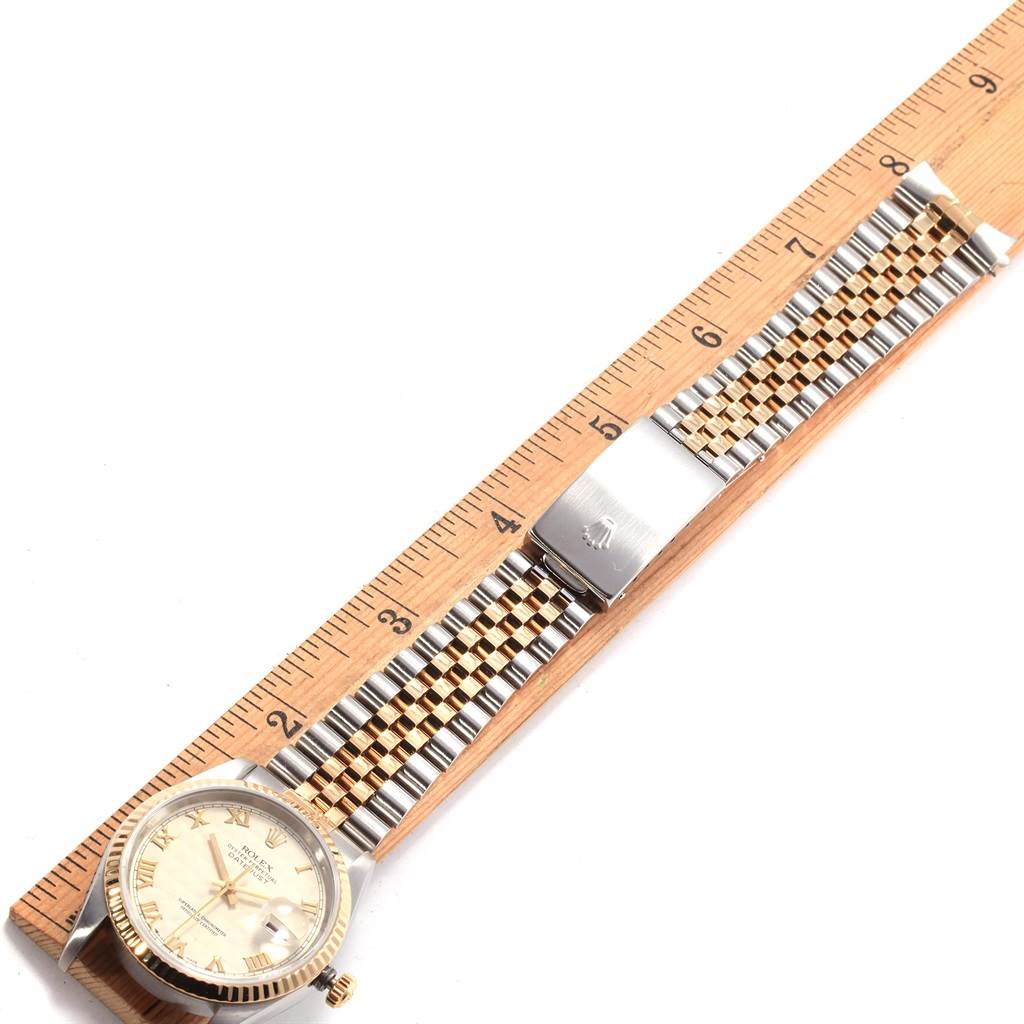 The image shows a horizontal view of the Rolex Datejust 16233 Men
s Stainless Steel Beige Dial 16233 Men
s Stainless Steel Beige Dial watch with its bracelet fully extended next to a ruler for scale.