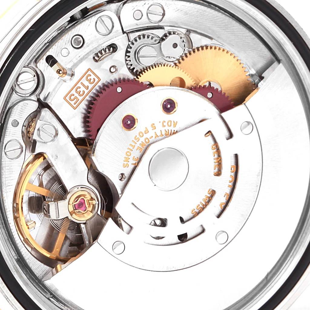 This image shows a close-up of the movement mechanism of a Rolex Datejust 16233 Men
s Stainless Steel Beige Dial 16233 Men
s Stainless Steel Beige Dial, highlighting gears, balance wheel, and rotor.