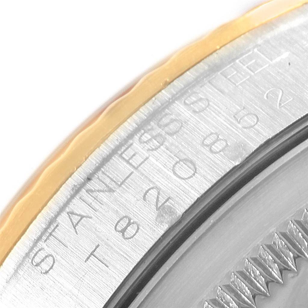 The image shows a close-up of the edge and engravings on the back case of a Rolex Datejust 16233 Men
s Stainless Steel Beige Dial 16233 Men
s Stainless Steel Beige Dial watch.