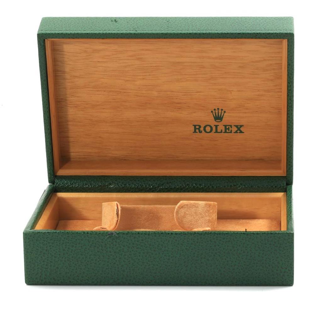 The image shows an open Rolex green watch box for the Datejust model, featuring a wooden interior and the Rolex logo.