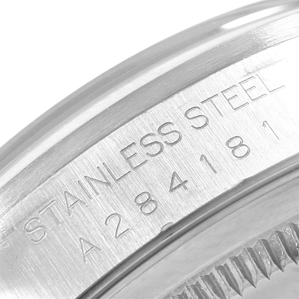 This image shows a close-up of the case, bezel, and serial number engraving on a Rolex Datejust 16200 Men's Stainless Steel Blue Dial 16200 Men's Stainless Steel Blue Dial watch.