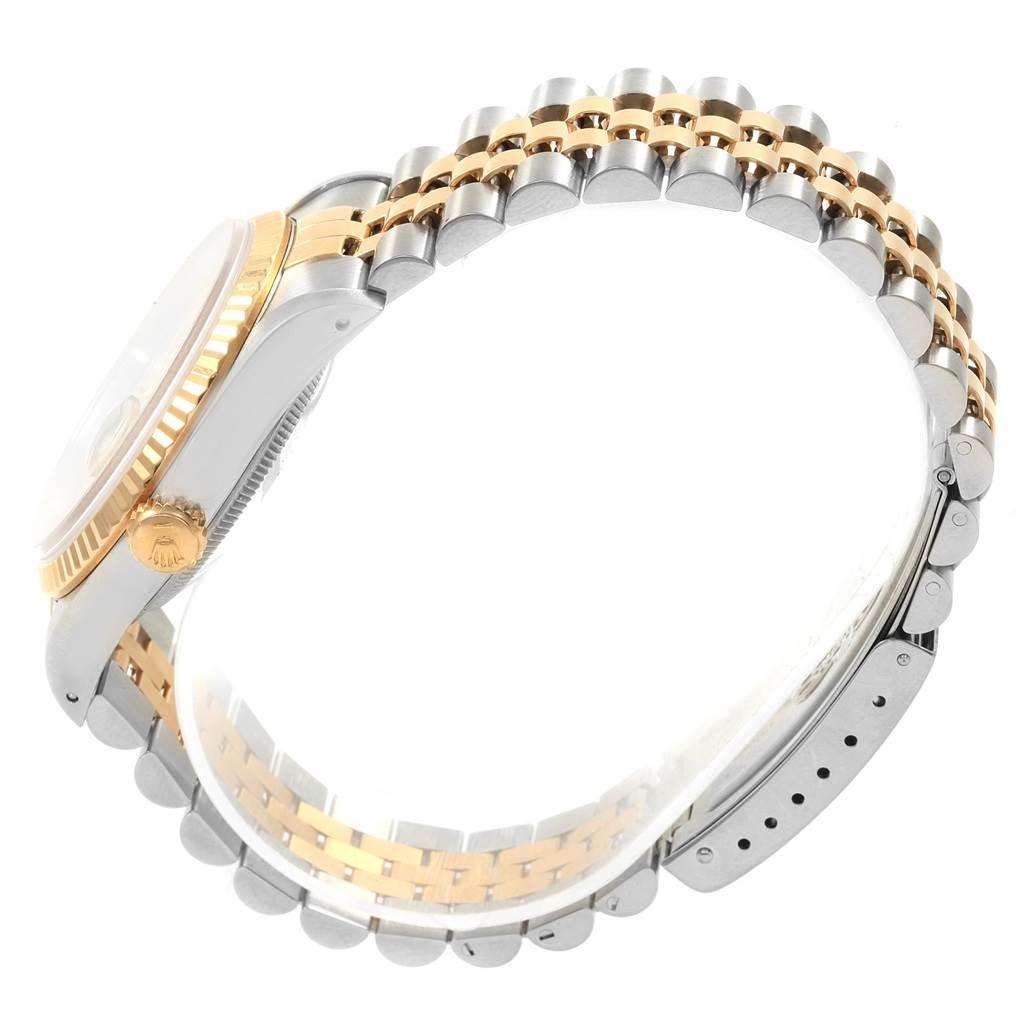 The Rolex Datejust 16233 Men's Stainless Steel Beige Dial 16233 Men's Stainless Steel Beige Dial watch is shown from a side angle, highlighting its two-tone bracelet and fluted bezel.