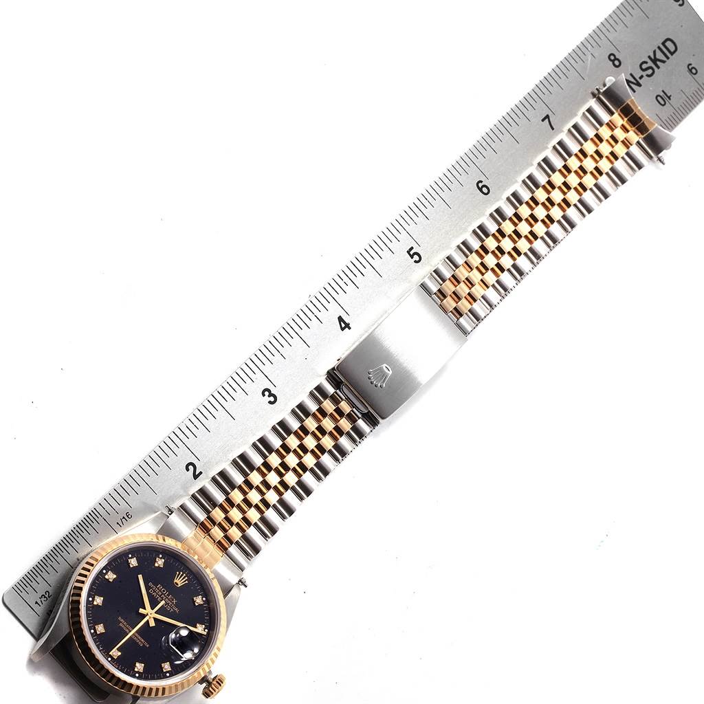 The image shows the front of a Rolex Datejust 16233 Men's Steel and Gold (two tone) Black Dial 16233 Men's Steel and Gold (two tone) Black Dial watch and its Jubilee bracelet, measured with a ruler.