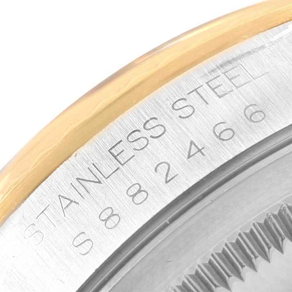 This image shows the stainless steel case back and part of the gold bezel of the Rolex Datejust 16233 Men's Steel and Gold (two tone) Black Dial 16233 Men's Steel and Gold (two tone) Black Dial watch.