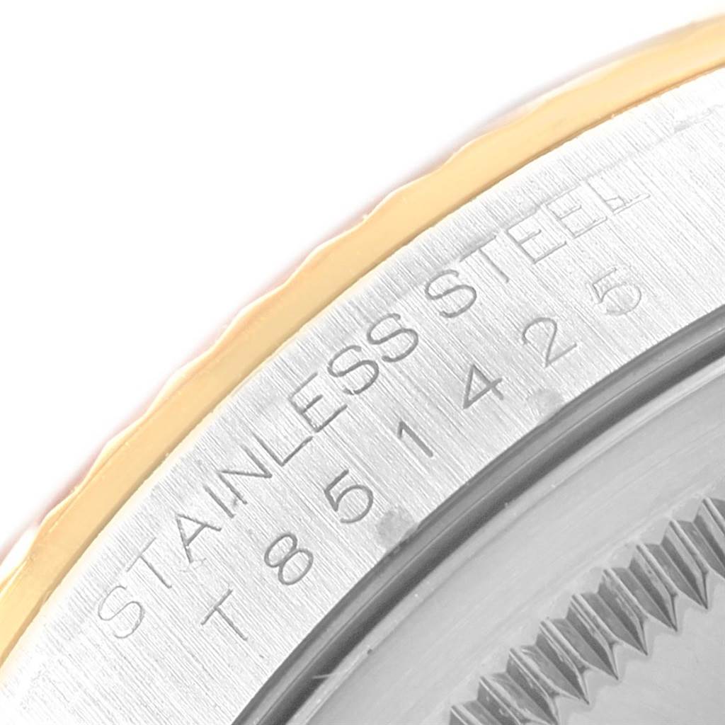 The image shows a close-up of the outer edge of a Rolex Datejust 16233 Men's Steel and Gold (two tone) Grey Dial 16233 Men's Steel and Gold (two tone) Grey Dial watch, highlighting the stainless steel text and part of the bezel.