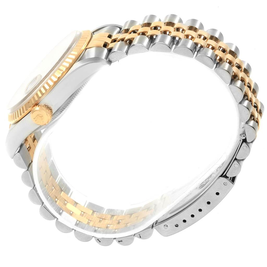 The image shows a side view of a Rolex Datejust 16233 Men's Steel and Gold (two tone) Grey Dial 16233 Men's Steel and Gold (two tone) Grey Dial watch, featuring its two-tone bracelet and a partial view of the crown and case.