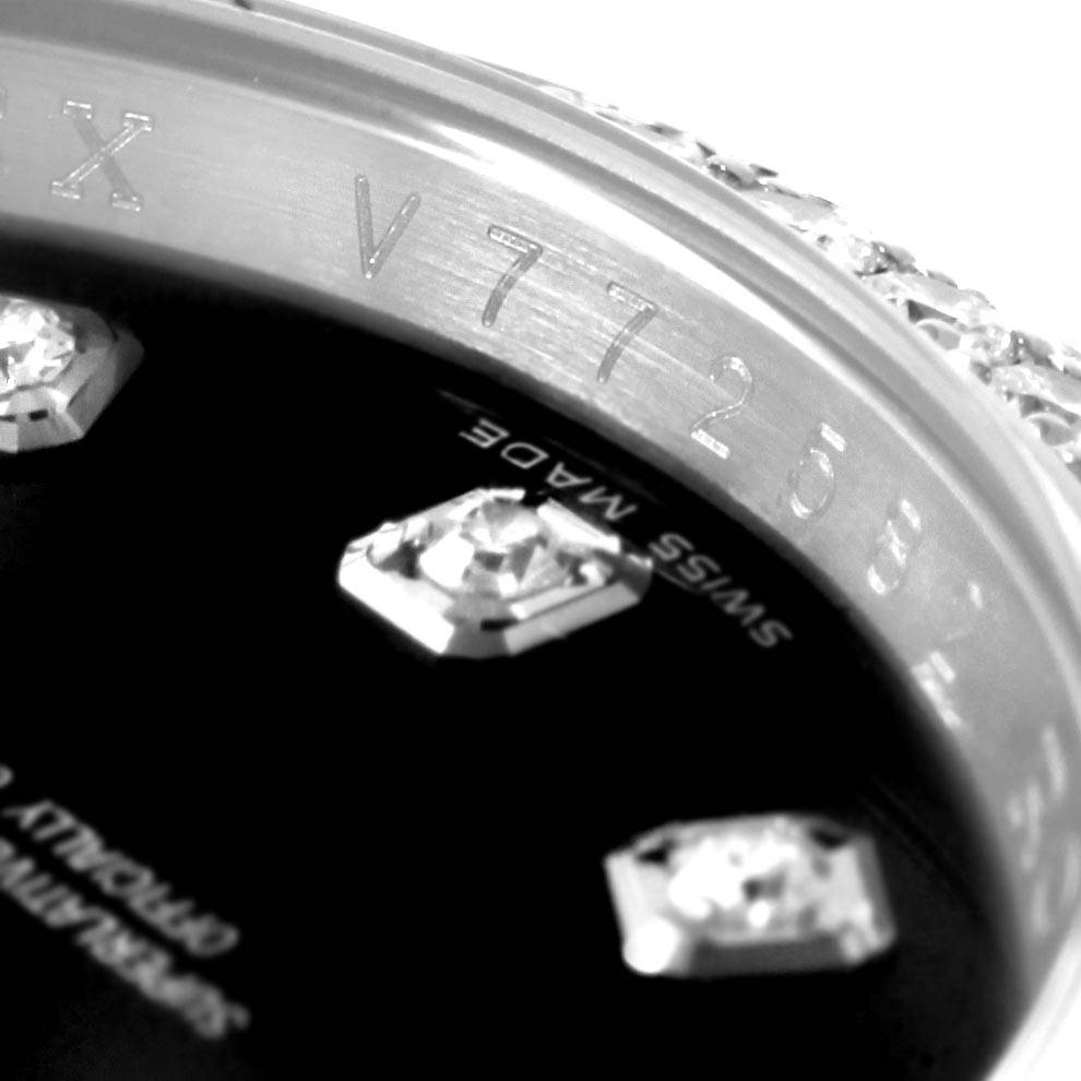 This close-up image of a Rolex Datejust 116244 Men
s Stainless Steel Black Dial 116244 Men
s Stainless Steel Black Dial watch shows the inner bezel with engraved serial numbers and part of the diamond-studded dial.