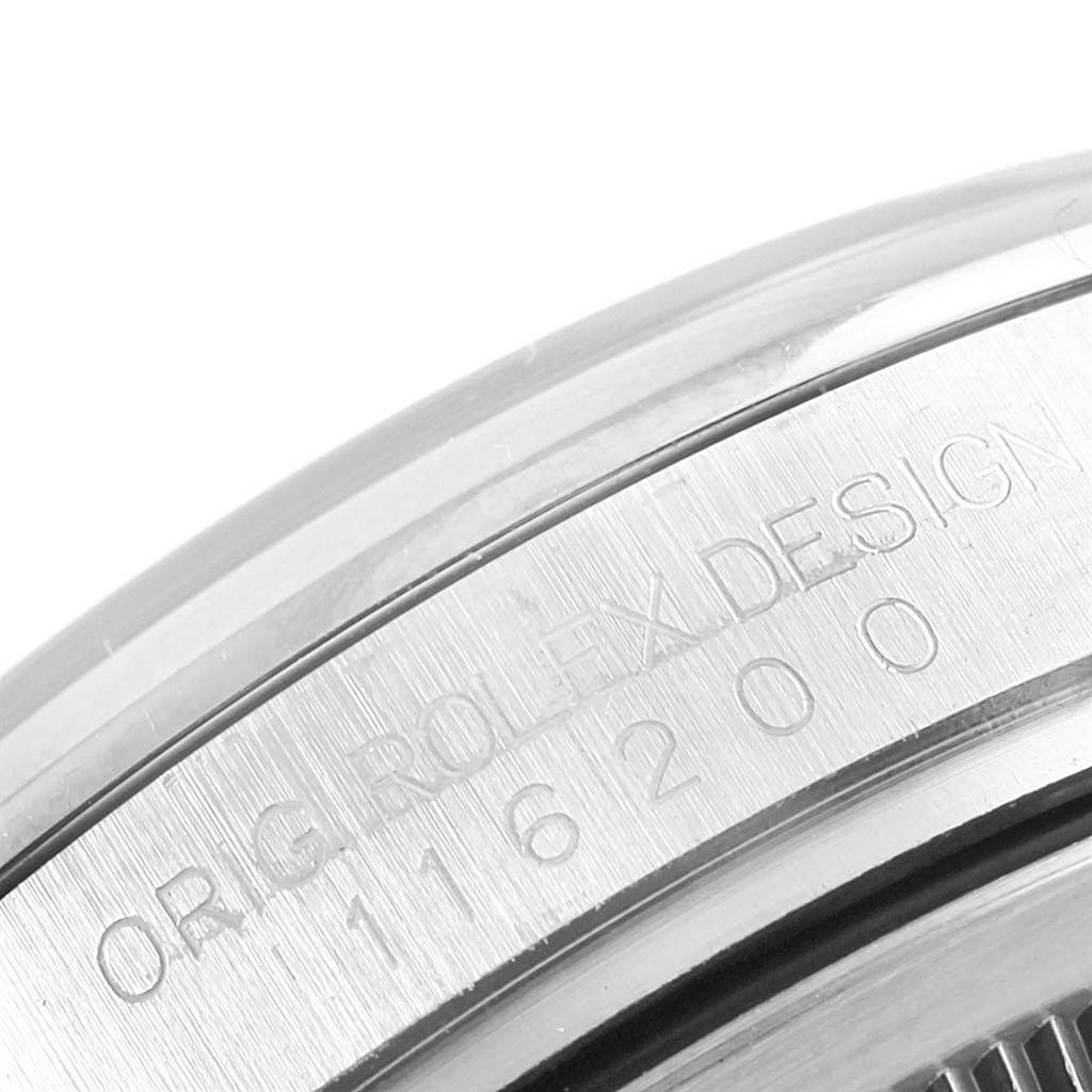 This close-up image features the engraved side of the case of a Rolex Datejust 116200 Men's Stainless Steel Grey Dial 116200 Men's Stainless Steel Grey Dial watch.