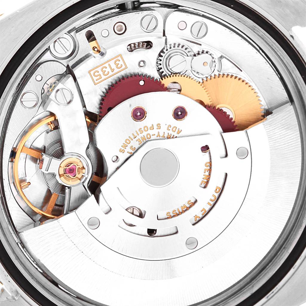 This image shows the intricate internal mechanism of a Rolex Datejust 116203 Men's Stainless Steel White Dial 116203 Men's Stainless Steel White Dial watch, including gears and the rotor.