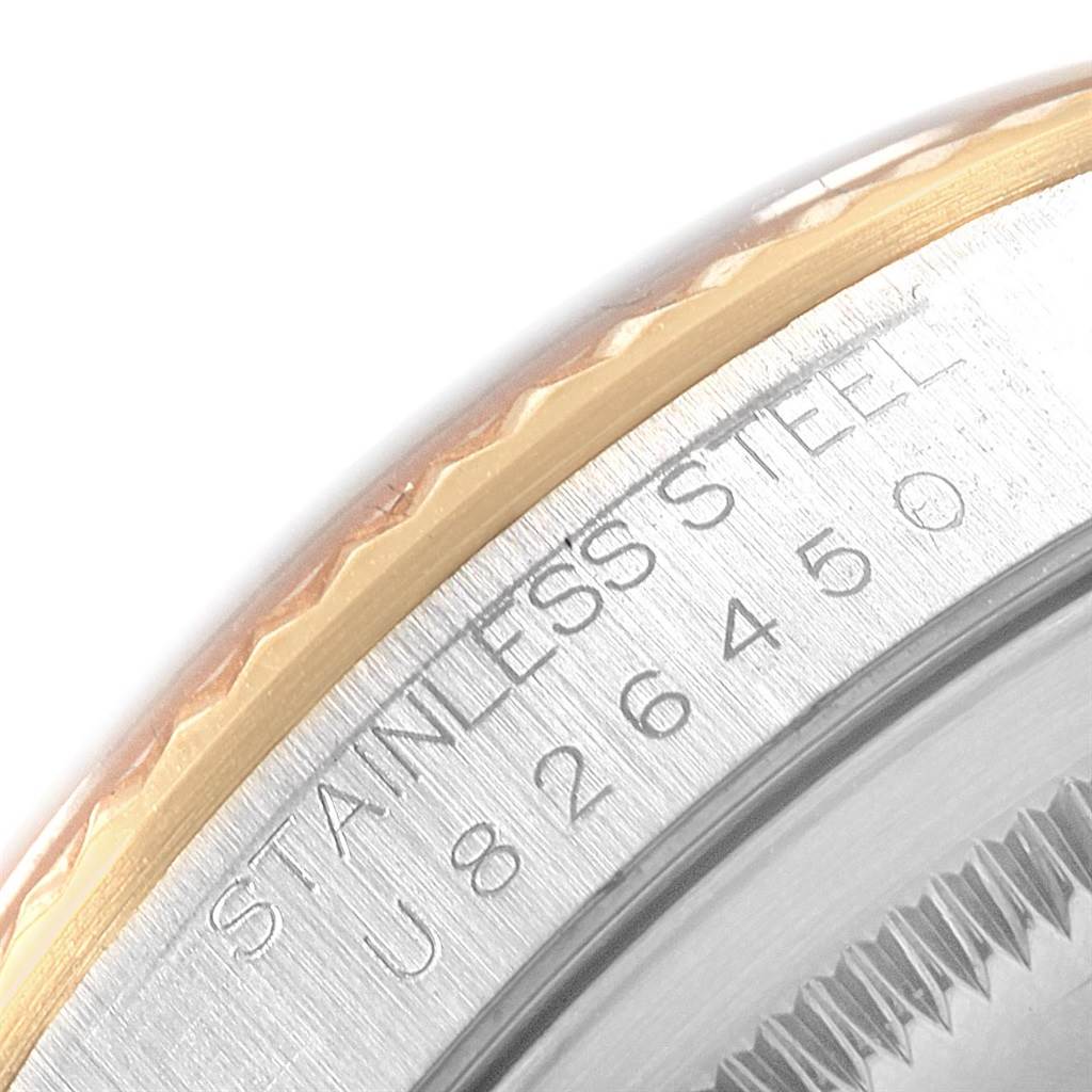 The image shows a close-up of the engraved stainless steel case and part of the bezel on a Rolex Datejust 16233 Men's Steel and Gold (two tone) Champagne Dial 16233 Men's Steel and Gold (two tone) Champagne Dial watch.