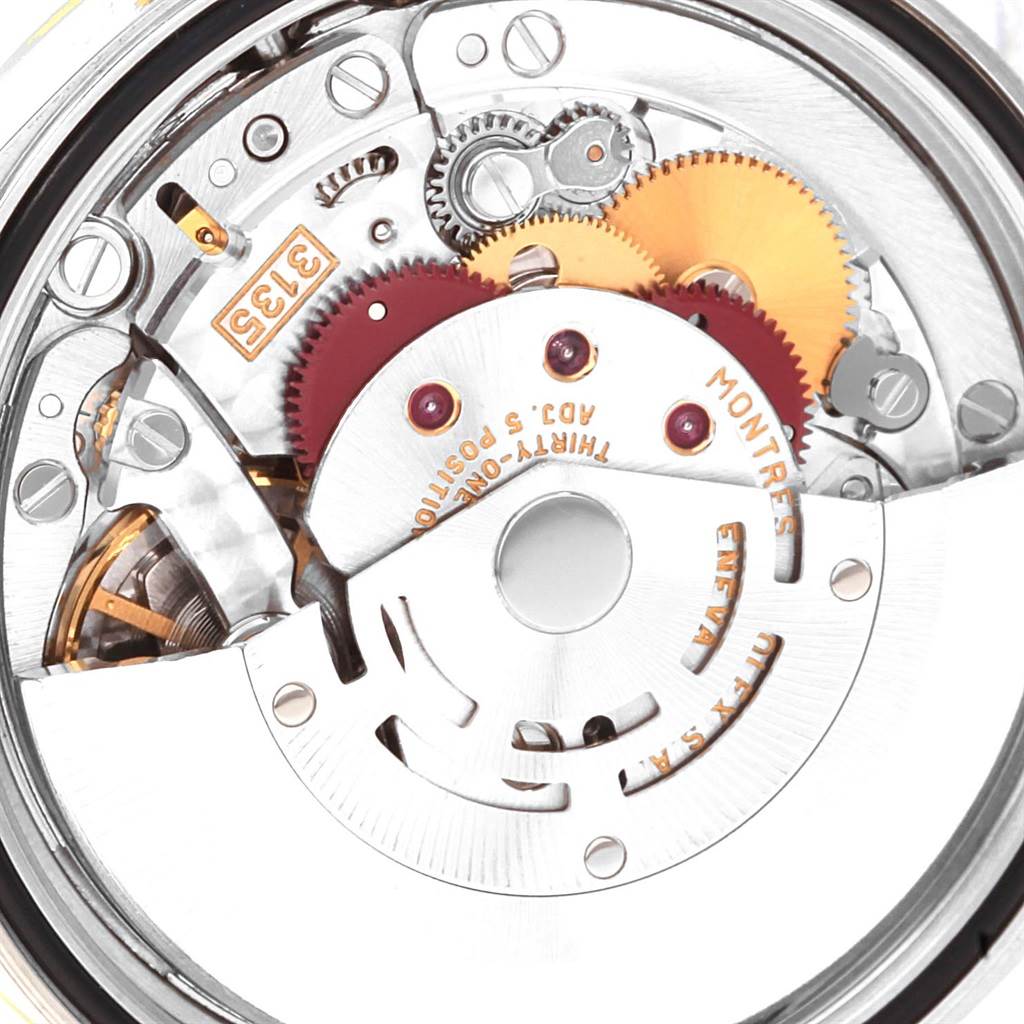 The image shows an internal close-up of the Rolex Datejust 16233 Men's Steel and Gold (two tone) Champagne Dial 16233 Men's Steel and Gold (two tone) Champagne Dial watch movement, featuring gears, springs, and other mechanical parts.