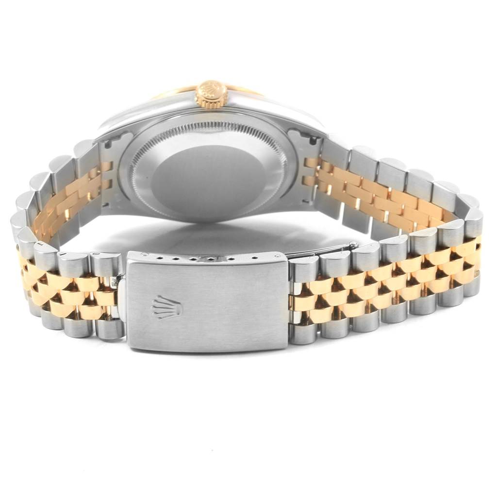 The image shows the underside of a Rolex Datejust 16233 Men's Steel and Gold (two tone) Champagne Dial 16233 Men's Steel and Gold (two tone) Champagne Dial watch, highlighting the two-tone bracelet, clasp, and case back.