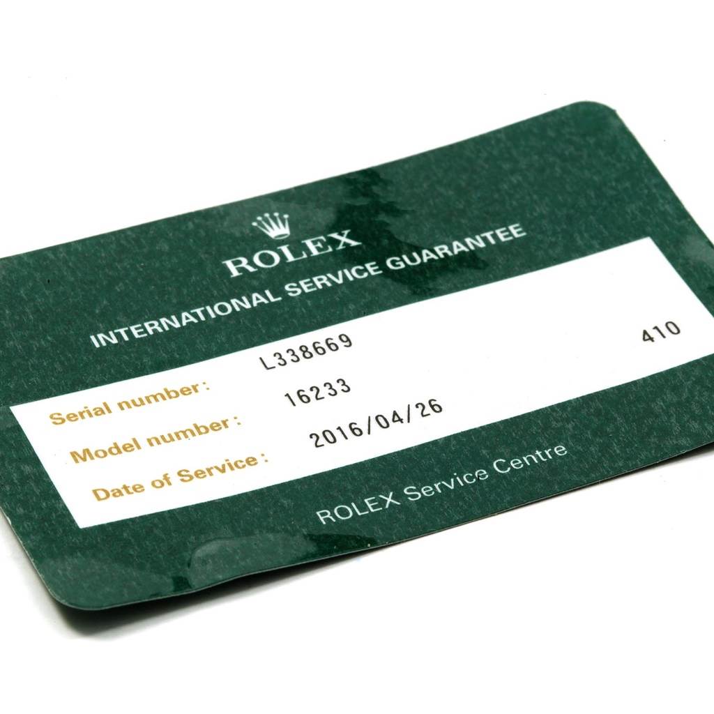This is an angled view of a Rolex International Service Guarantee card for a Rolex Datejust 16233 Men's Steel and Gold (two tone) White Dial 16233 Men's Steel and Gold (two tone) White Dial model.