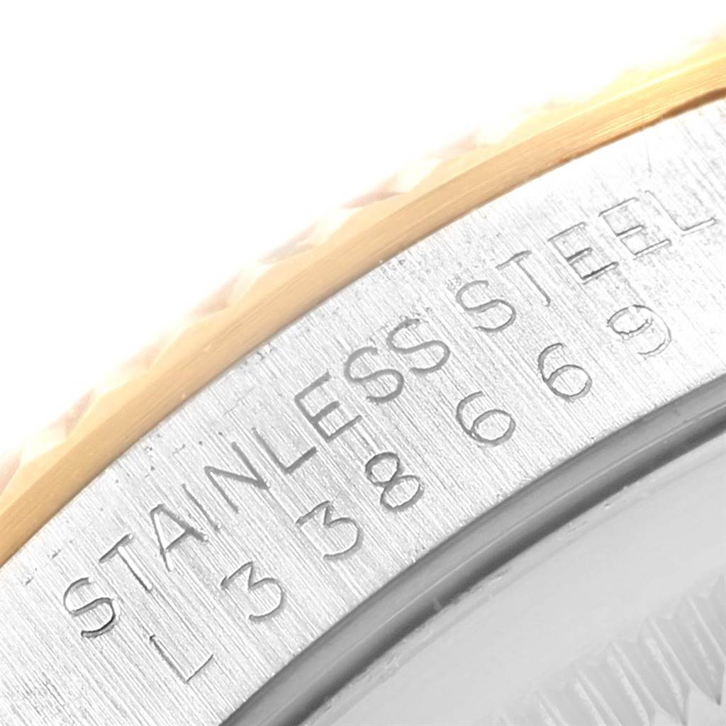 The image shows a close-up of the edge and serial number engraving on the bezel of a Rolex Datejust 16233 Men's Steel and Gold (two tone) White Dial 16233 Men's Steel and Gold (two tone) White Dial watch.
