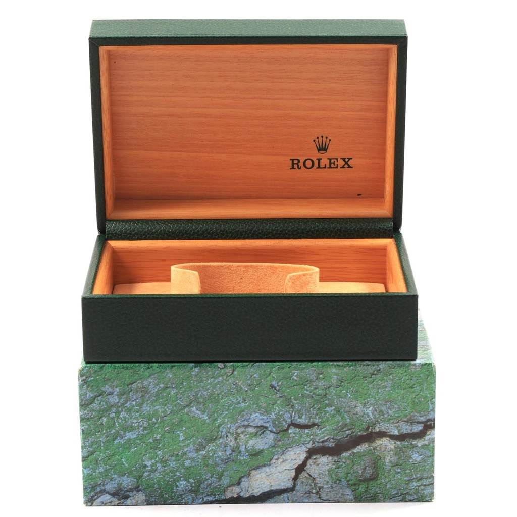 The image shows the open green and wood Rolex box for the Datejust model, featuring the Rolex logo inside the lid.