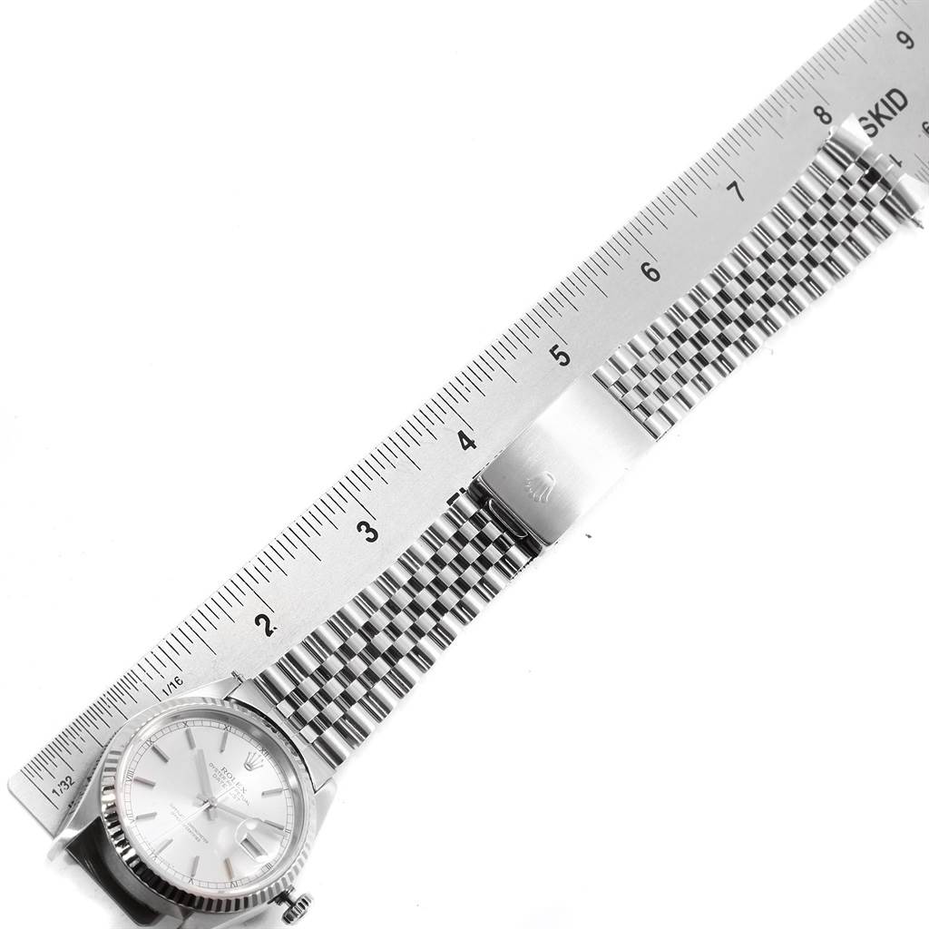 The image shows a top-down view of a Rolex Datejust 16234 Men's Stainless Steel Silver Dial 16234 Men's Stainless Steel Silver Dial watch, displaying the face, bracelet, and clasp alongside a ruler.