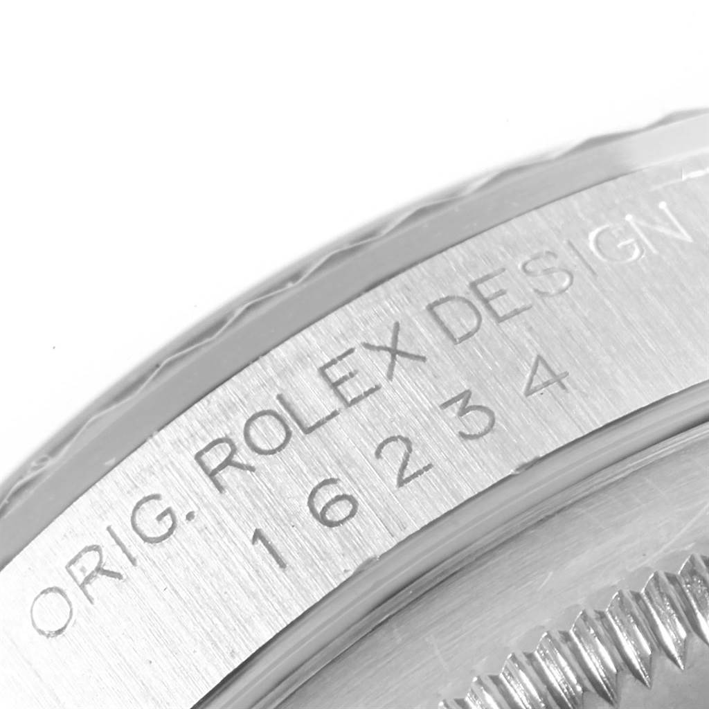 The image shows a close-up of the casing and bezel with engravings on a Rolex Datejust 16234 Men's Stainless Steel Silver Dial 16234 Men's Stainless Steel Silver Dial model watch.