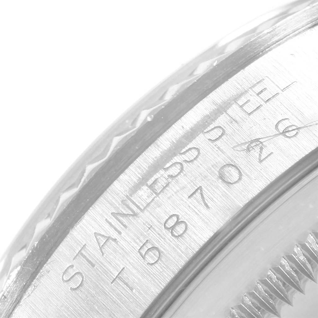 This close-up view of a Rolex Datejust 16234 Men's Stainless Steel Silver Dial 16234 Men's Stainless Steel Silver Dial watch shows part of the bezel and its stainless steel engraving.
