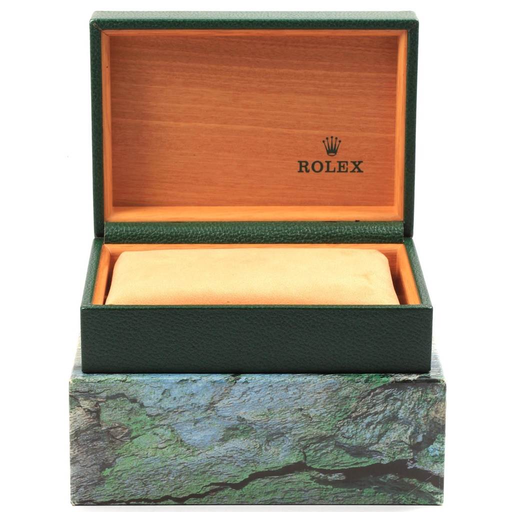 The image shows an open Rolex watch box, likely for the Datejust model, with a cushion and the Rolex logo visible.