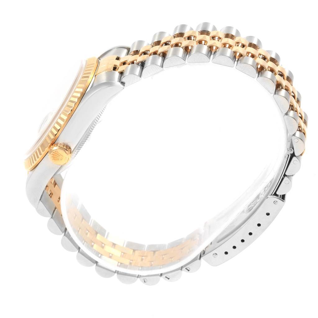 The image shows a side view of a Rolex Datejust 16233 Men's Steel and Gold (two tone) White Dial 16233 Men's Steel and Gold (two tone) White Dial watch, focusing on the two-tone bracelet and bezel.