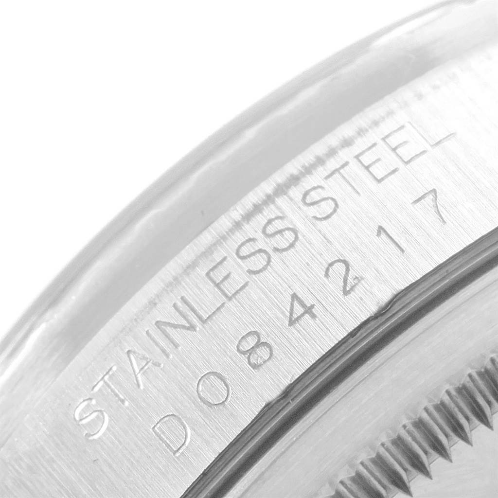 The image shows a close-up of the engraving on the stainless steel case back of a Rolex Datejust 16220 Men
s Stainless Steel Black Dial 16220 Men
s Stainless Steel Black Dial watch.