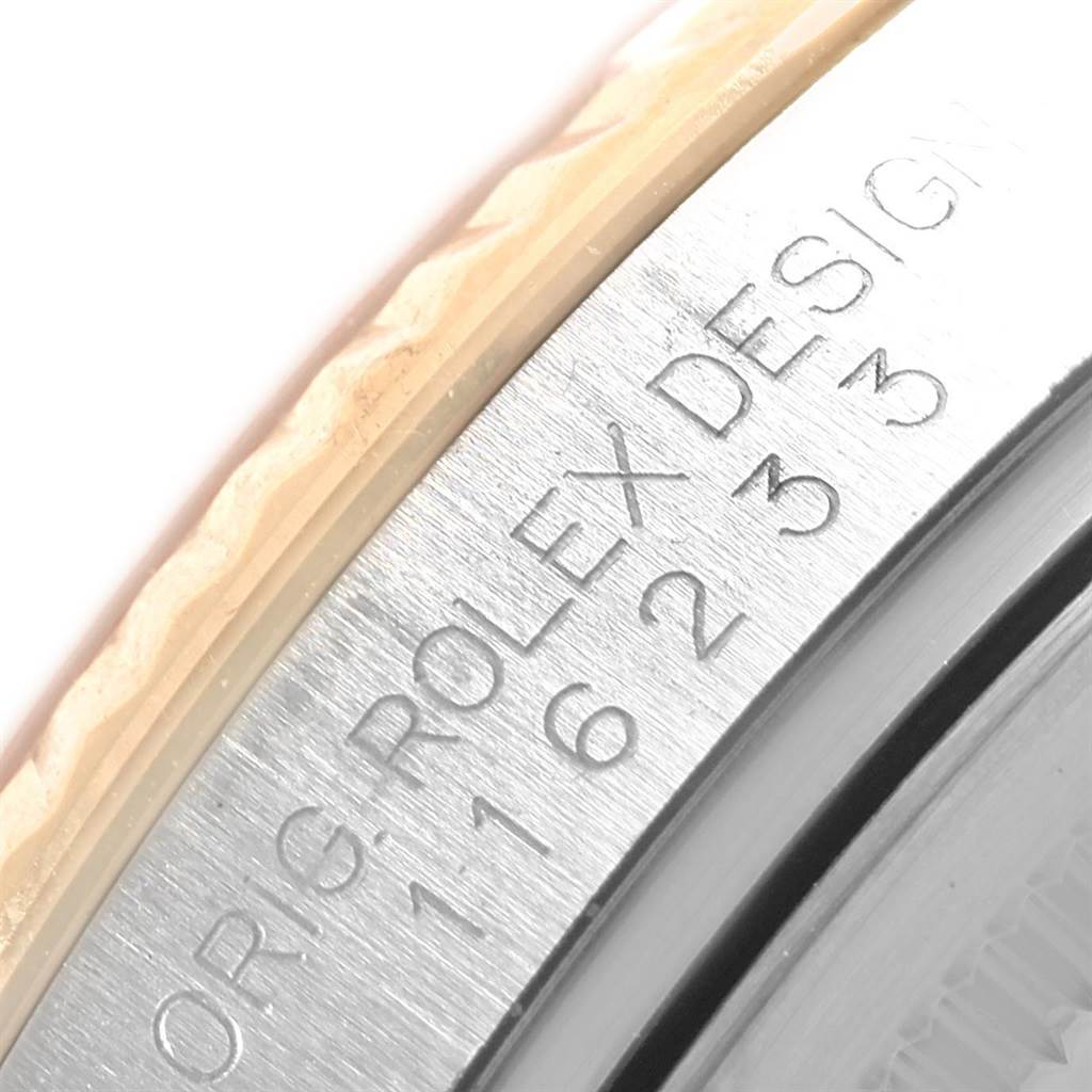 This close-up image shows the engraving on the case side and part of the bezel of a Rolex Datejust 116233 Men
s Stainless Steel Blue Dial 116233 Men
s Stainless Steel Blue Dial watch.