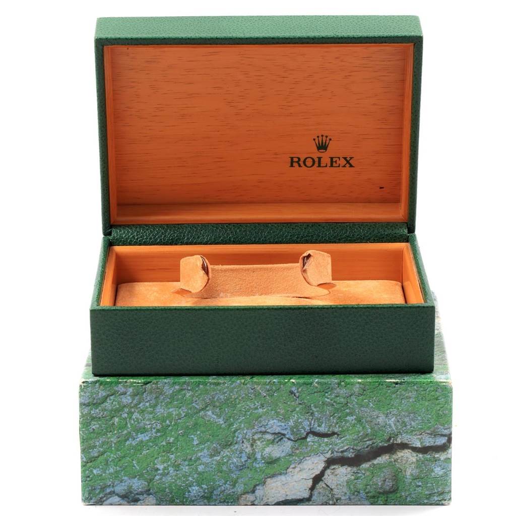This image shows an open green Rolex watch box with a wooden interior for the Datejust model.