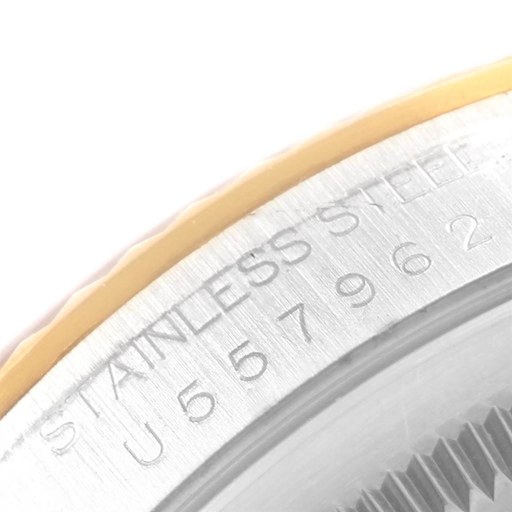 This image shows a close-up of the stainless steel edge and engraved serial number of a Rolex Datejust 16233 Men's Steel and Gold (two tone) Grey Dial 16233 Men's Steel and Gold (two tone) Grey Dial watch.