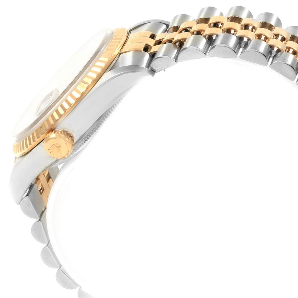 The image shows a side view of a Rolex Datejust 16233 Men's Steel and Gold (two tone) Grey Dial 16233 Men's Steel and Gold (two tone) Grey Dial watch, highlighting its crown, bezel, and two-tone bracelet.