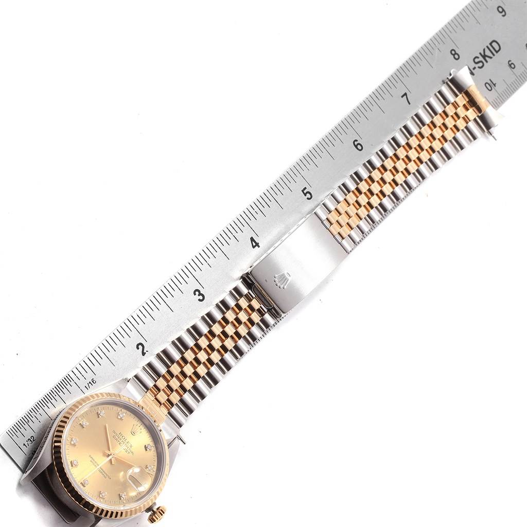 The image shows a top-down view of a Rolex Datejust 16233 Men's Steel and Gold (two tone) Champagne Dial 16233 Men's Steel and Gold (two tone) Champagne Dial watch, focusing on the face, bracelet, and clasp, next to a ruler for scale.
