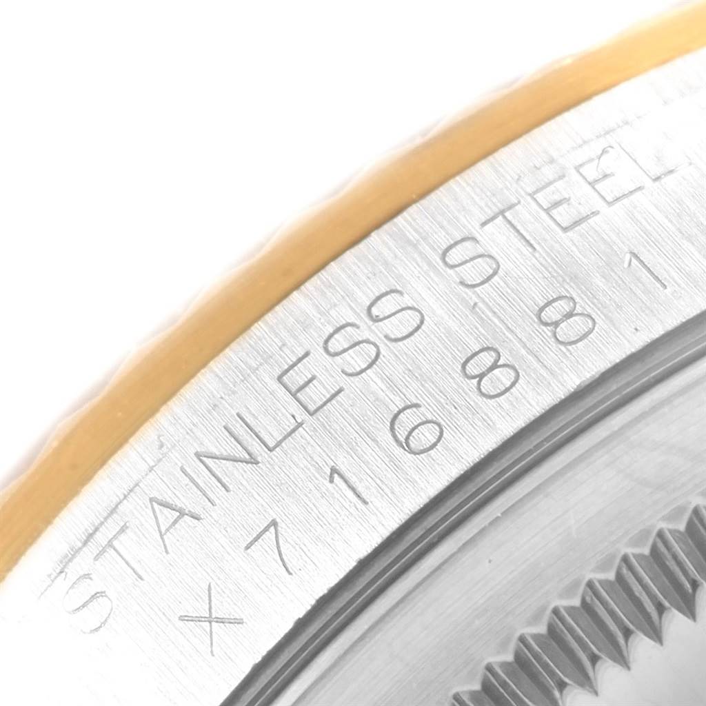 This close-up of a Rolex Datejust 16233 Men's Steel and Gold (two tone) Champagne Dial 16233 Men's Steel and Gold (two tone) Champagne Dial shows part of the case back with "STAINLESS STEEL" and the serial number inscribed.