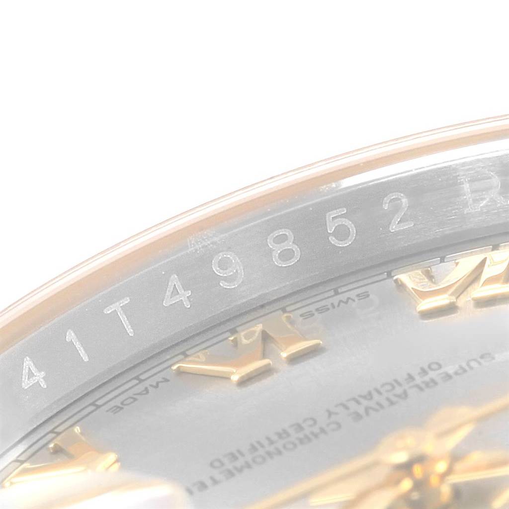 The image shows a close-up angle of the Rolex Datejust 116233 Men's Stainless Steel Silver Dial 116233 Men's Stainless Steel Silver Dial model, focusing on the serial number engraved inside the case and part of the dial with Roman numerals.