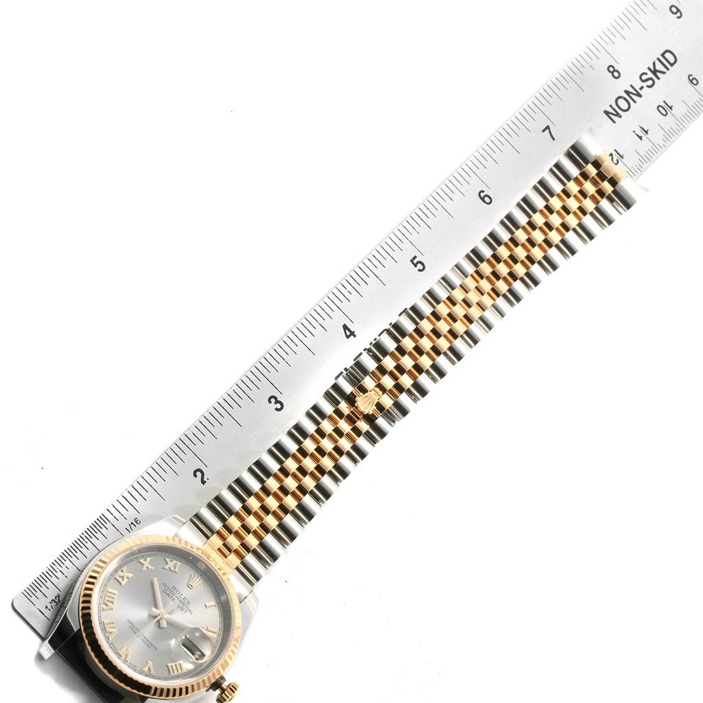 The image shows a Rolex Datejust 116233 Men's Stainless Steel Silver Dial 116233 Men's Stainless Steel Silver Dial watch viewed from the top, highlighting the face and bracelet next to a ruler.