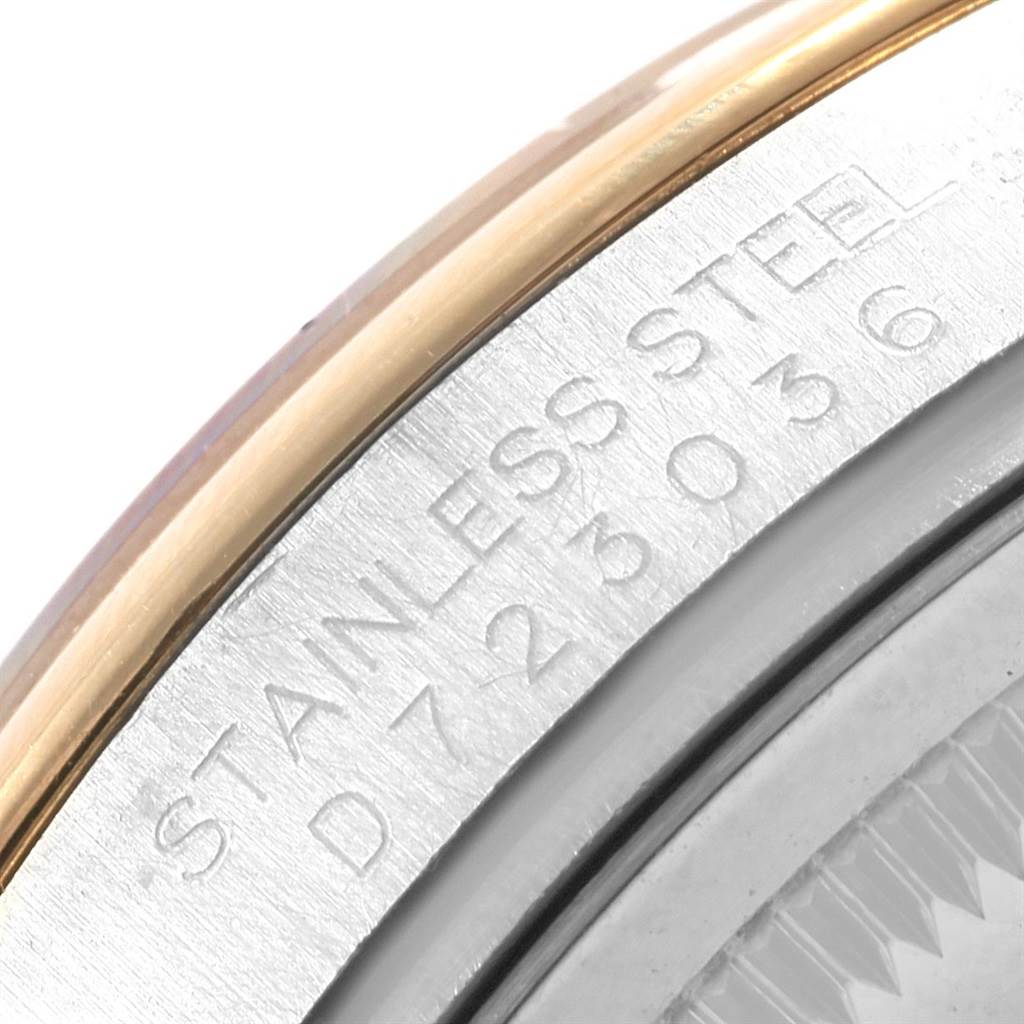 This close-up image of the Rolex Datejust 116203 Men's Stainless Steel Champagne Dial 116203 Men's Stainless Steel Champagne Dial model shows the case frame and parts of the bezel with engraving.