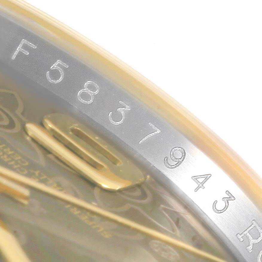 This image shows a close-up of the serial number engraved on the bezel of a Rolex Datejust 116243 Men
s Stainless Steel Brown Dial 116243 Men
s Stainless Steel Brown Dial watch.