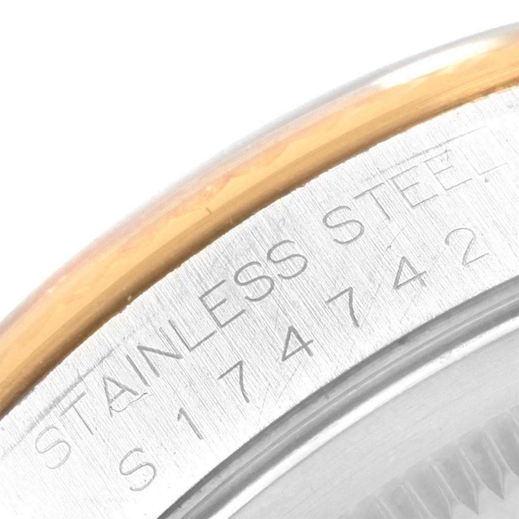 This close-up image of the Rolex Datejust 16233 Men's Steel and Gold (two tone) Champagne Dial 16233 Men's Steel and Gold (two tone) Champagne Dial watch shows the engraved stainless steel case with a glimpse of the bezel.