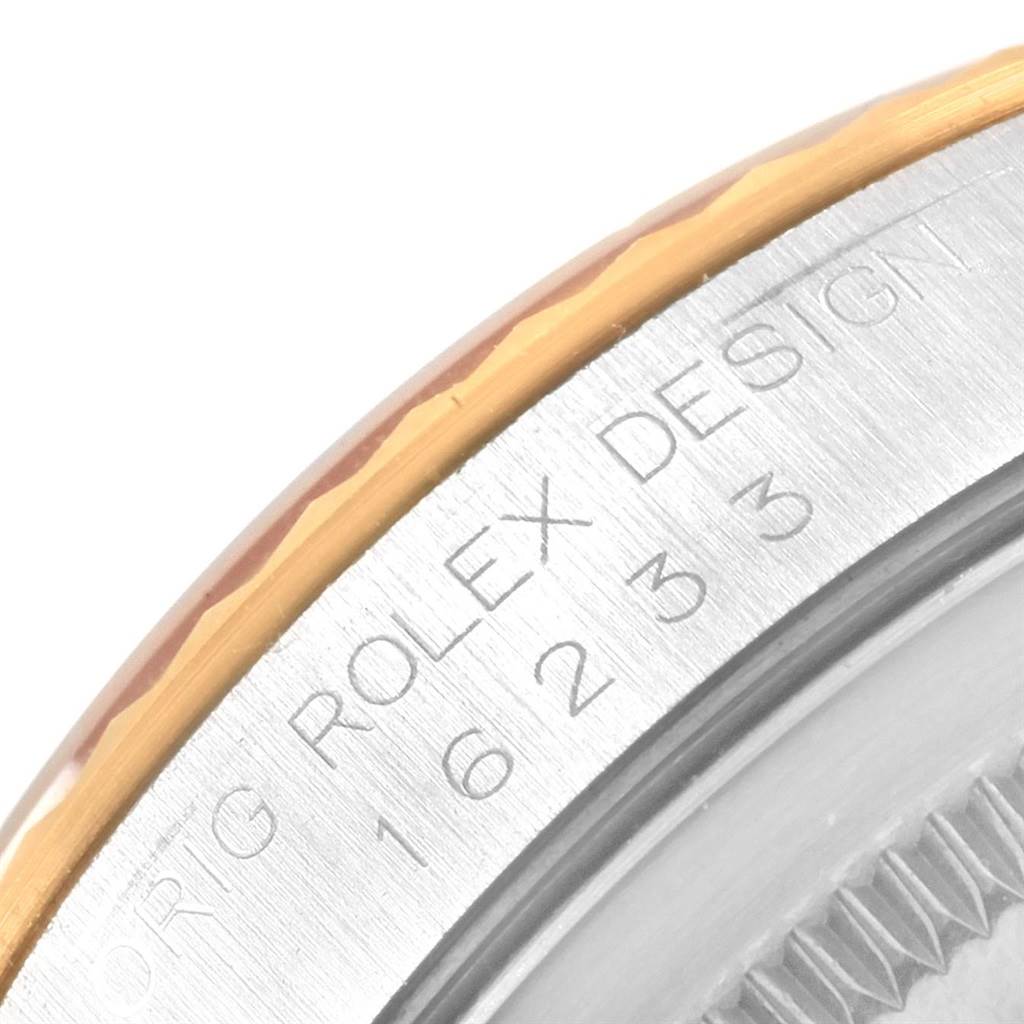 This close-up image shows the engraved side of the bezel and part of the case of a Rolex Datejust 16233 Men's Steel and Gold (two tone) Champagne Dial 16233 Men's Steel and Gold (two tone) Champagne Dial watch.