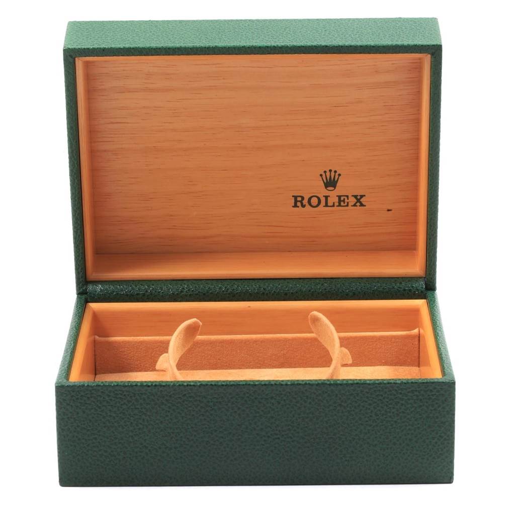 The image shows an open green Rolex watch box for the Datejust model, with compartments for holding the watch securely.
