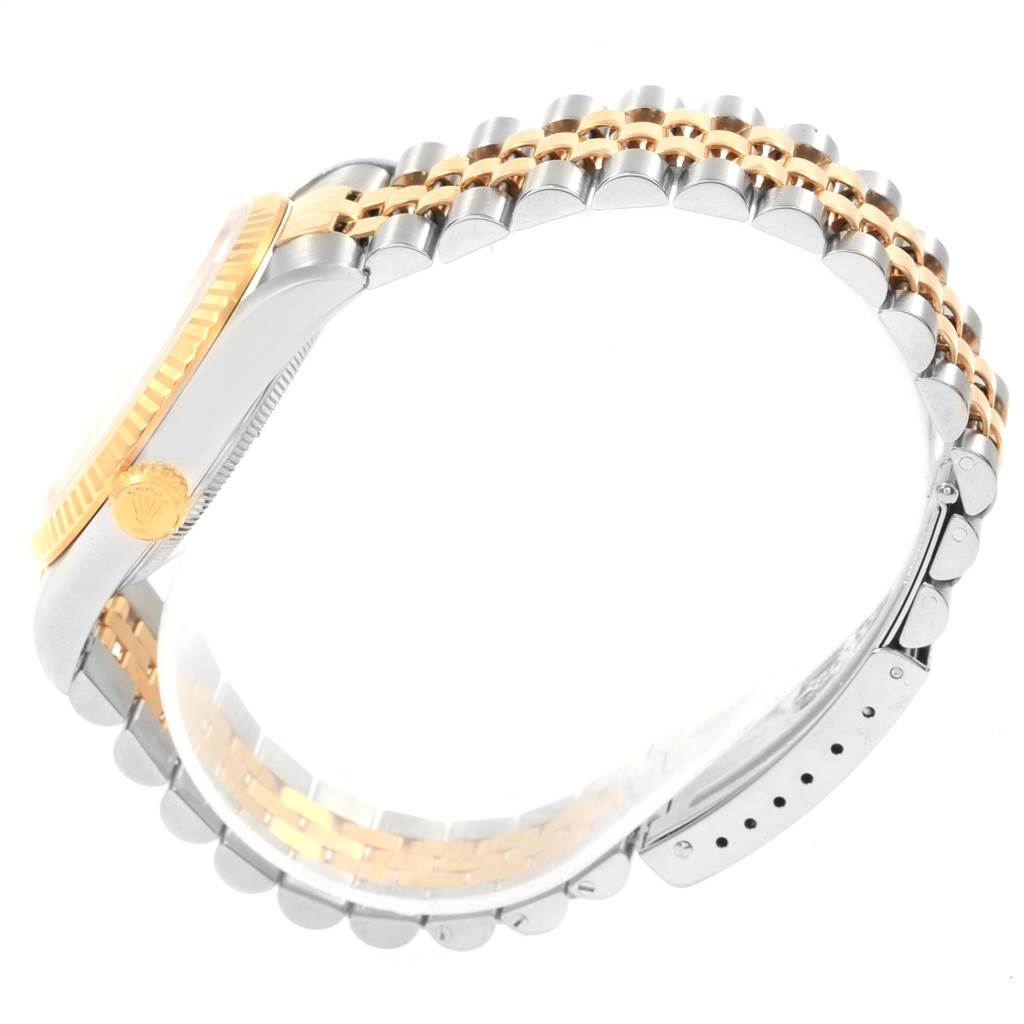 The image shows the side view of a Rolex Datejust 16233 Men's Steel and Gold (two tone) Champagne Dial 16233 Men's Steel and Gold (two tone) Champagne Dial watch, focusing on the bezel, crown, and two-tone metal bracelet.