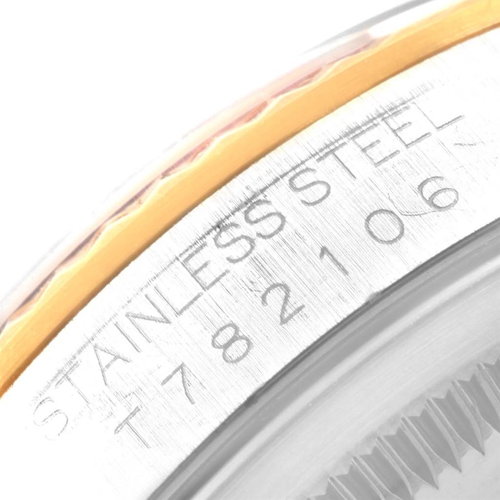 This close-up image of the Rolex Datejust 16233 Men's Steel and Gold (two tone) Champagne Dial 16233 Men's Steel and Gold (two tone) Champagne Dial watch shows a portion of the stainless steel case with engraved markings.