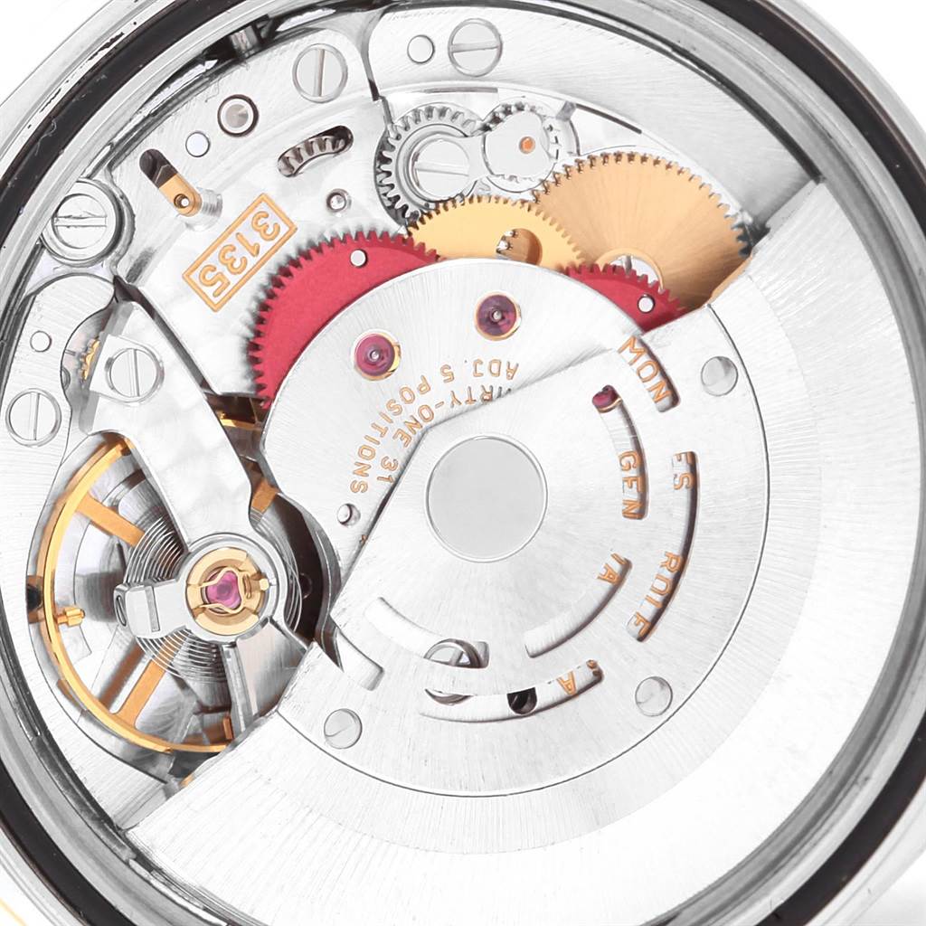This is an internal view of the Rolex Datejust 16233 Men's Steel and Gold (two tone) White Dial 16233 Men's Steel and Gold (two tone) White Dial movement, showing gears, rotors, and other intricate mechanisms.
