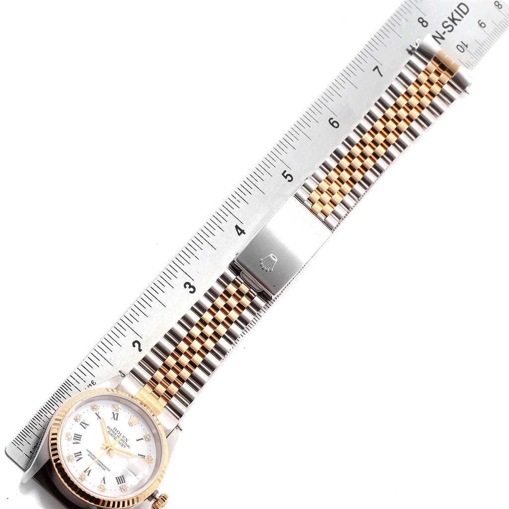 The image shows a Rolex Datejust 16233 Men's Steel and Gold (two tone) White Dial 16233 Men's Steel and Gold (two tone) White Dial watch placed next to a ruler, displaying the watch face and a portion of the bracelet.