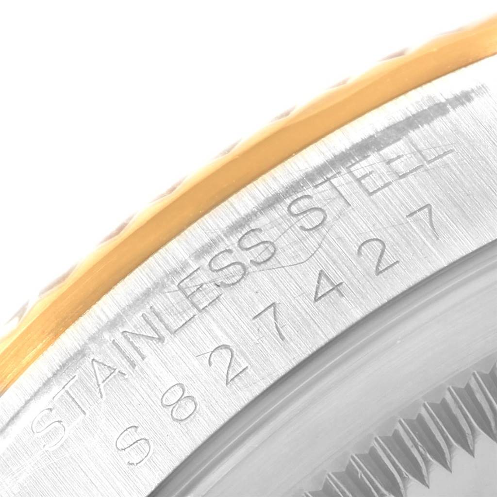 This image shows a close-up angle of the case and bezel of the Rolex Datejust 16233 Men's Steel and Gold (two tone) White Dial 16233 Men's Steel and Gold (two tone) White Dial watch, highlighting the engravings.