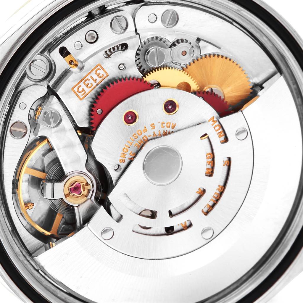 The image shows the intricate inner mechanism of the Rolex Datejust 16233 Men's Steel and Gold (two tone) White Dial 16233 Men's Steel and Gold (two tone) White Dial watch from a close-up angle.